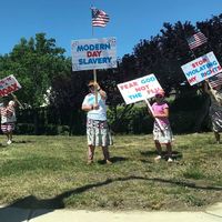 protestors holding signs against lock down