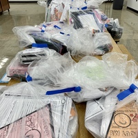 Plastic bags of things students left behind, laid out on cafeteria table.