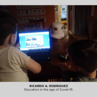 Photo of two children in front of a computer. 