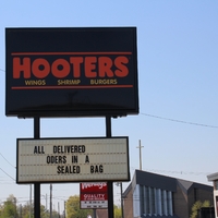 A restaurant sign reading "All Delivered Orders in a Sealed Bag".