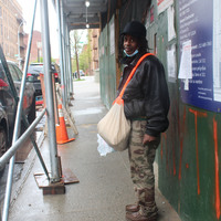 A man with a satchel and a mask. 