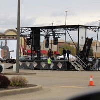 Photo of a stage in a mall parking lot.