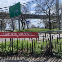 a red sign showing the distance people need to say apart