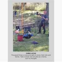 Photo of two people and ropes hanging from trees. 