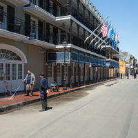 Two people washing an empty street.