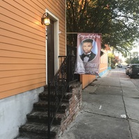 Brick stair case leading to a front door that has a banner with a senior photo and text, "Congratulations: Tyler Jones: Class of 2020: McKinley"