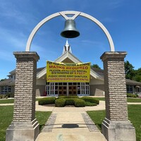 A church sign reading "For your protection and others: Masks Required. Please practice social distancing of 6 feet! Please bring hand sanitizer. Gathering Before or After Mass Not Permitted!".