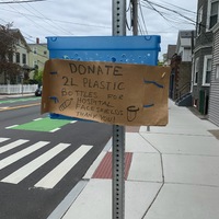 Sign asking for 2L water bottles to use for hospital face shields.