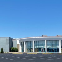 Photo of an empty parking lot outside a movie theater. 