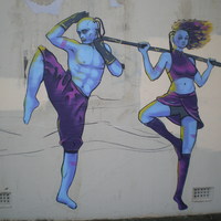 A mural with two people exercizing. 