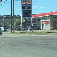 Image of a gas station sign during the pandemic. The price reads $1.61.