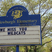 An elementary school sign reading "We Miss You Wildcats". 