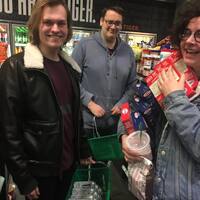 Three men in a grocery store.