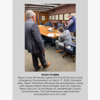 Photo of three men signing documents.