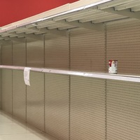 White empty shelves are shown with a can of campbell's sitting on the shelf. 