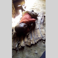 A child sleeping on a mat.