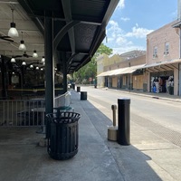 An empty street with numerous stores. 