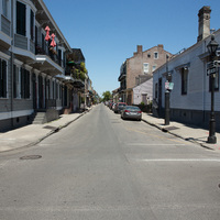 An empty street with cars parked along it.