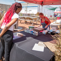 A costumer and employee at Clesi’s Seafood food tent.