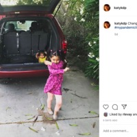 A Facebook screenshot of a photo of two little girls playing in and around a red van. 