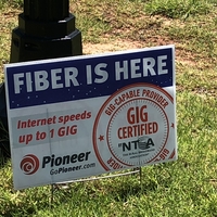 A photo of a lawn sign advertising upgraded internet speeds.