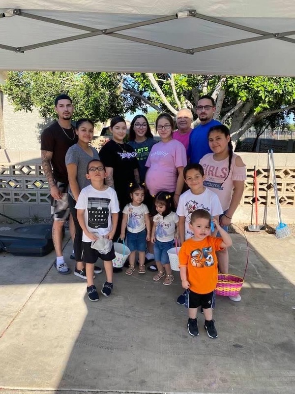 A family poses together. 