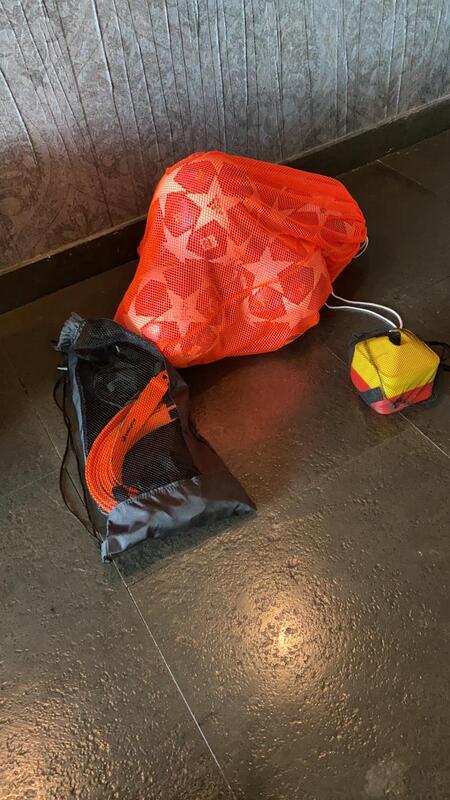 Soccer equipment in three bags. 