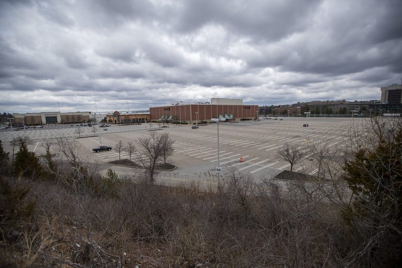 Burlington Mall's parking lot almost entirely empty aside from a few vehicles. 