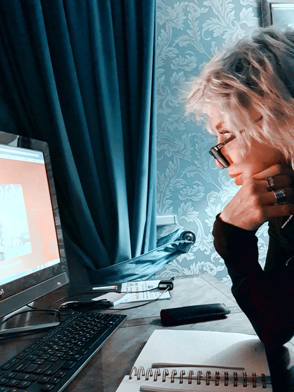 A person looking at a computer monitor. 