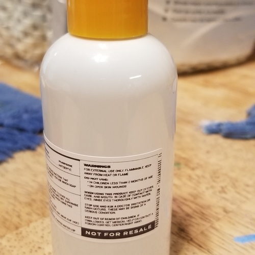 A orange and white hand sanitizer bottle. 