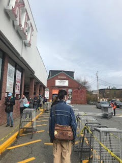 A line of people at a market.