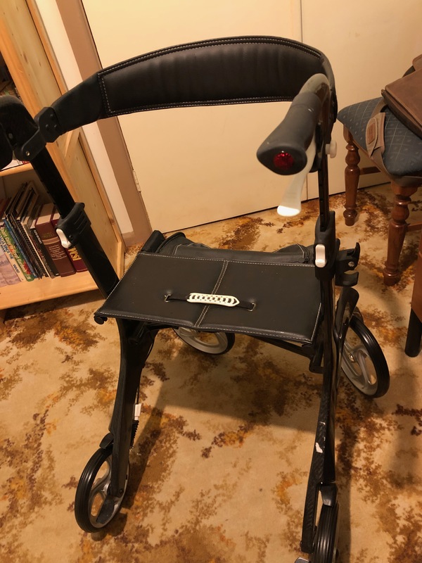 A black walker with wheels.