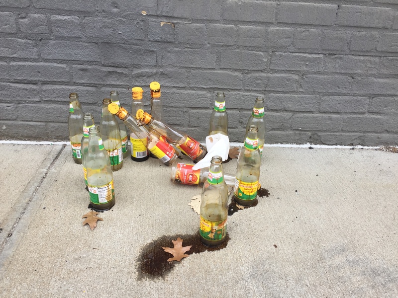 Many empty bottles on the ground. 
