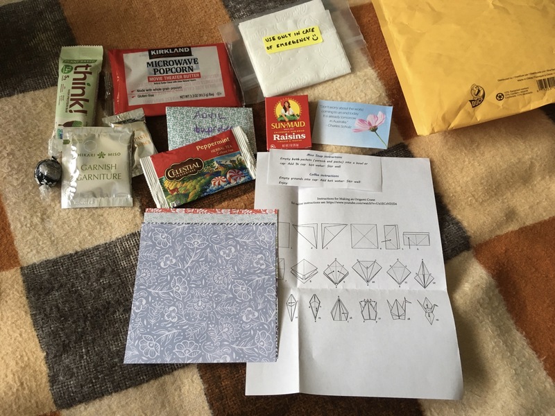 Toiletries and other items on a bed. 